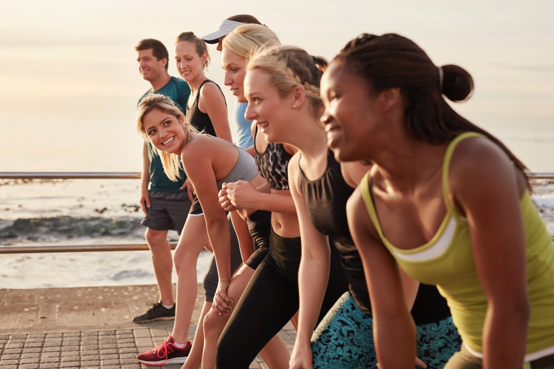 A running group training by the sea.